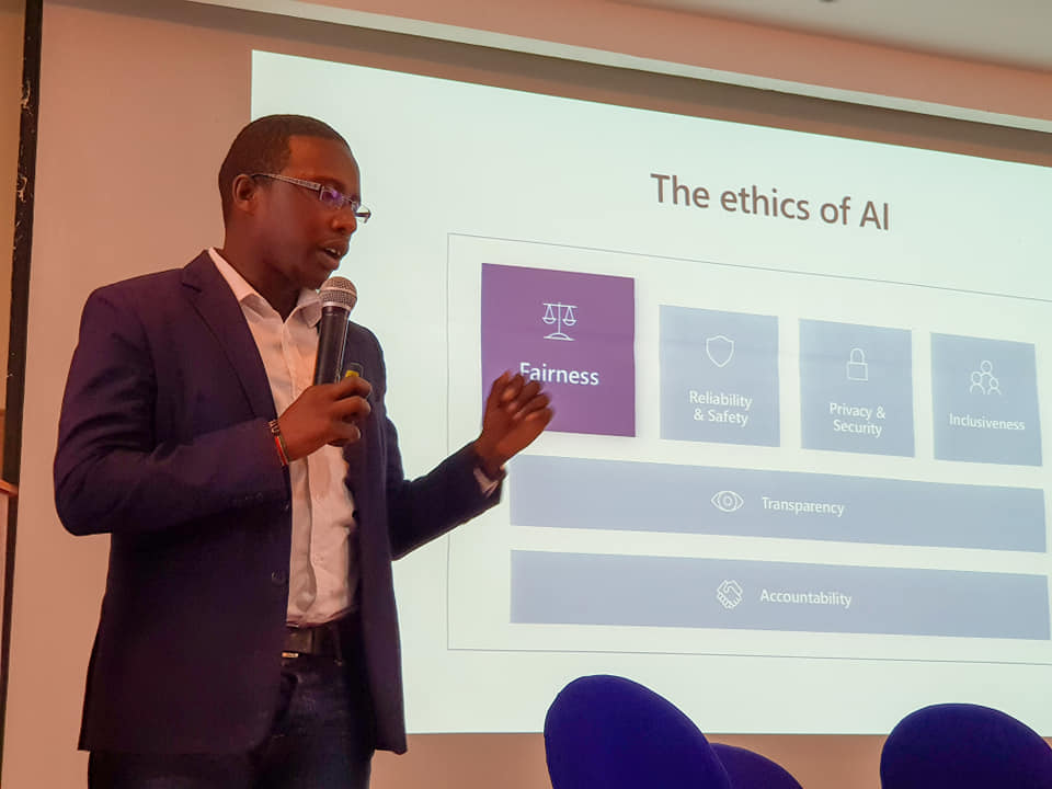 Somet Kipchilat speaking in front of a slide titled The ethics of AI