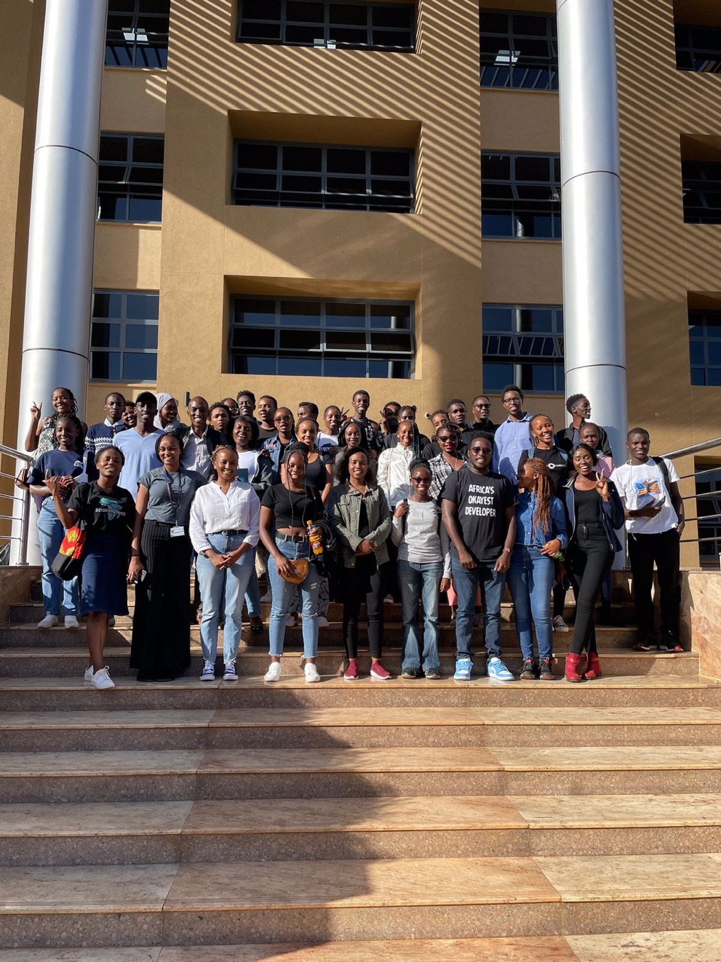 A large group photo on the steps of a building
