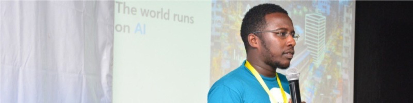 Somet Kipchilat speaking in front of a slide that reads The world runs on AI